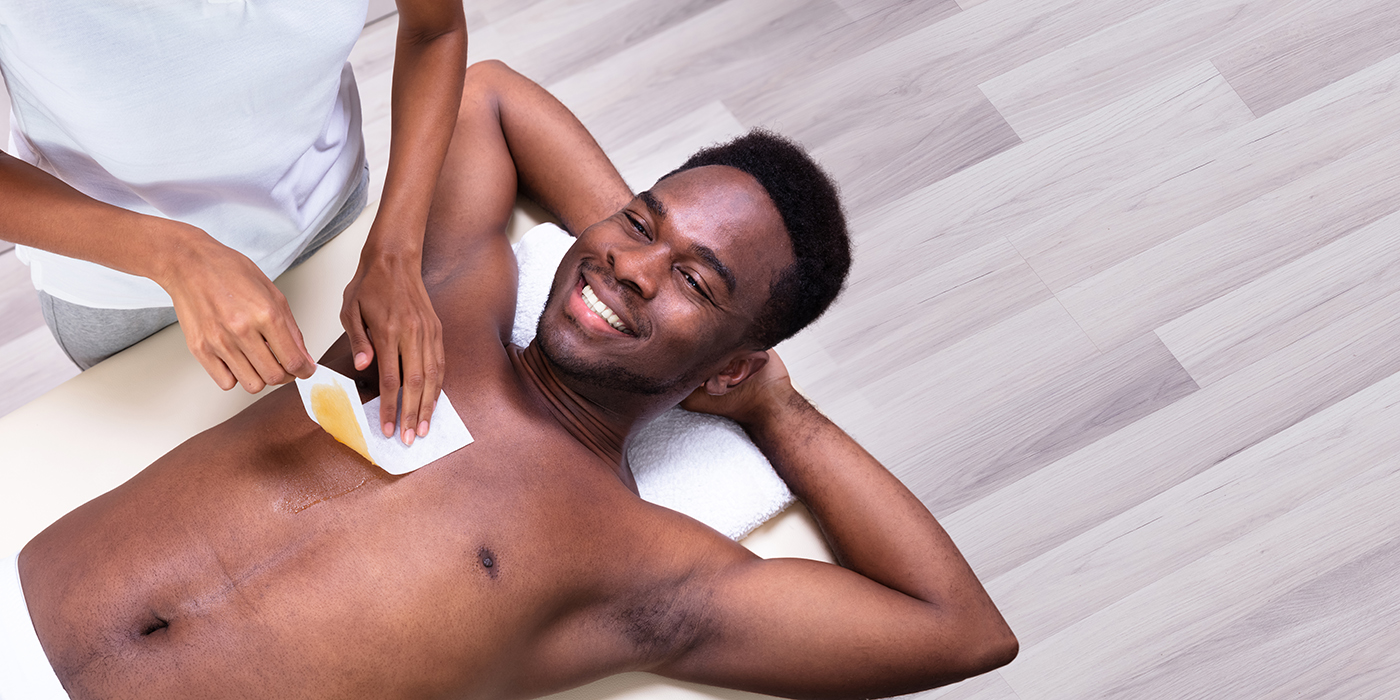 Person Hands Waxing Man's Chest