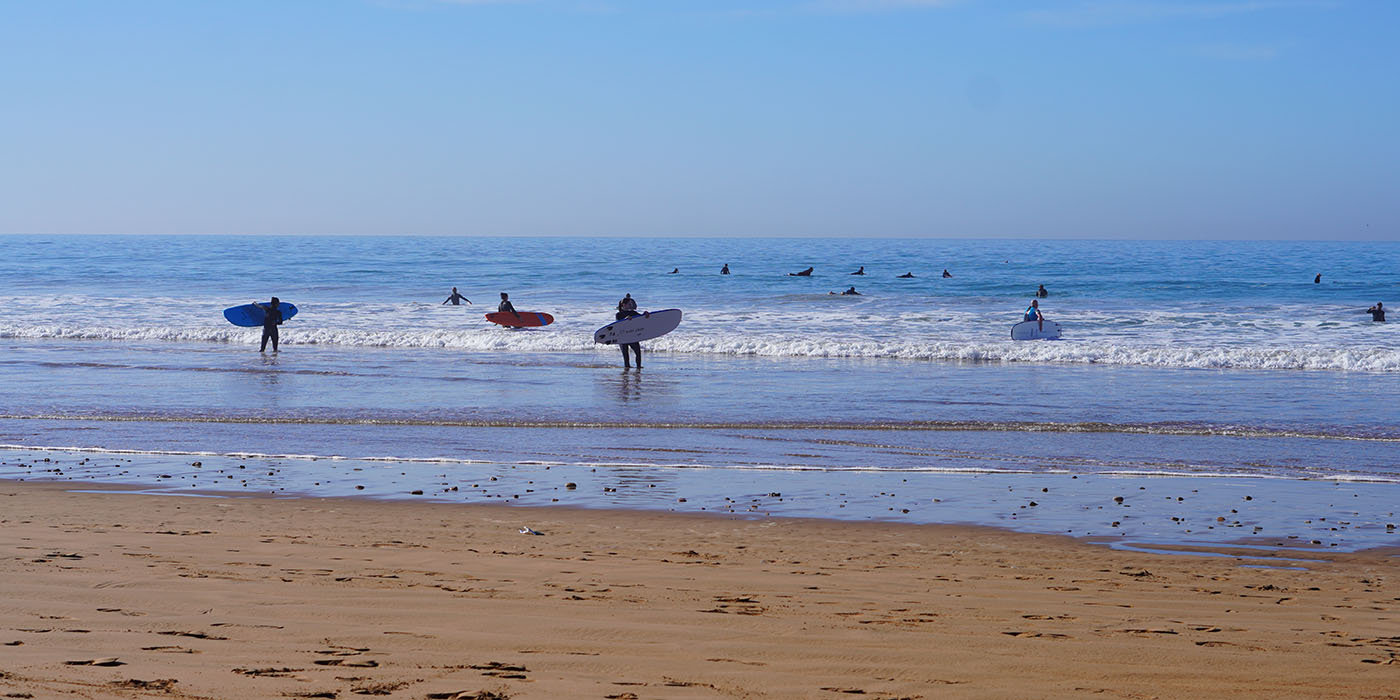 sufrers waiting to catch the wave