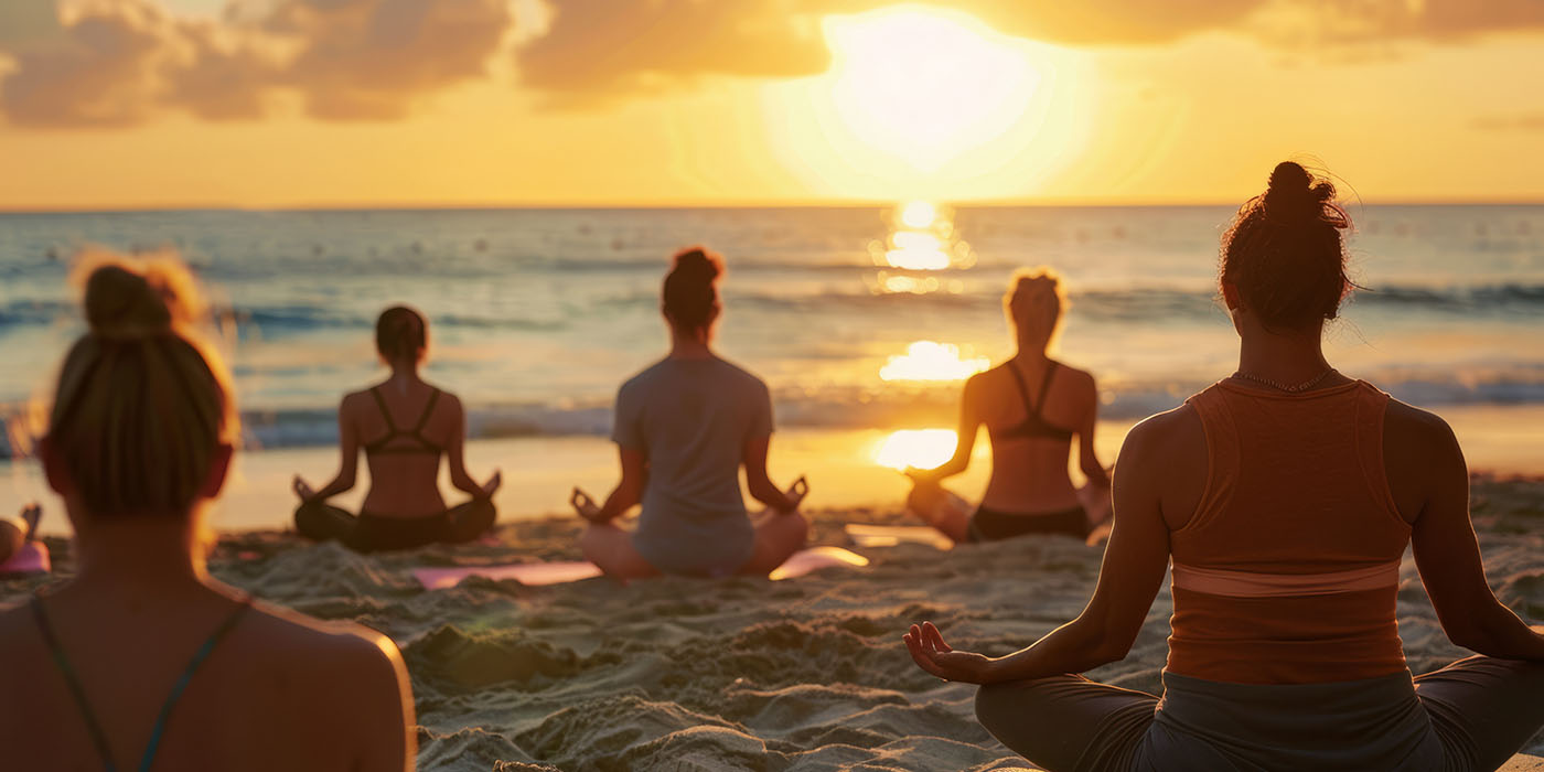 a beach yoga session at sunrise with diverse participants